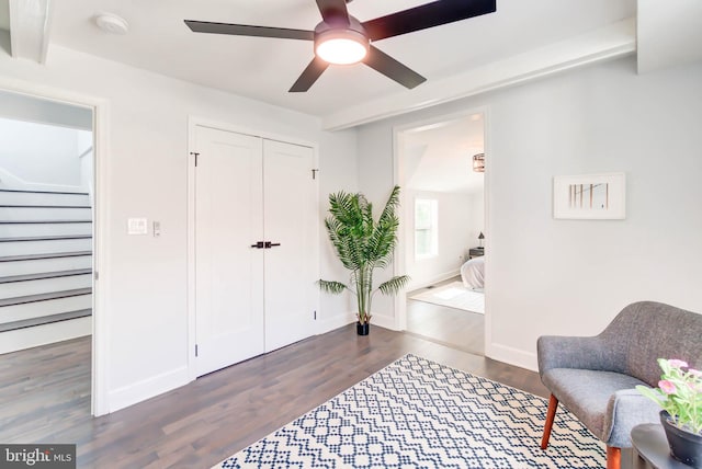 living area with ceiling fan, stairway, wood finished floors, and baseboards