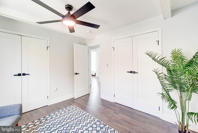 bedroom featuring beamed ceiling, dark hardwood / wood-style floors, a closet, and ceiling fan