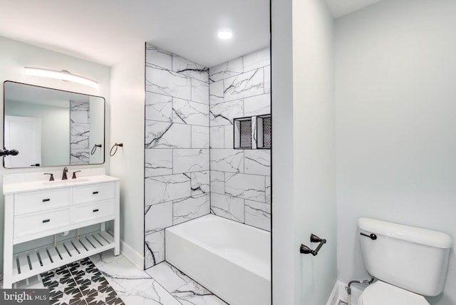 full bathroom featuring vanity, tiled shower / bath combo, and toilet