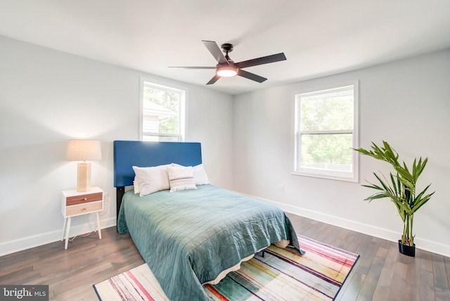 bedroom featuring ceiling fan, wood finished floors, and baseboards