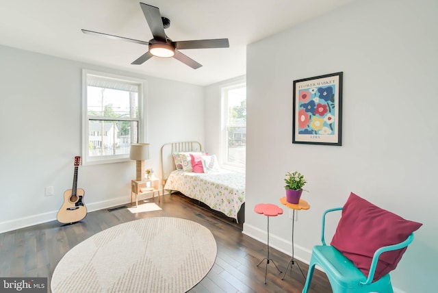 bedroom with wood finished floors, a ceiling fan, visible vents, and baseboards