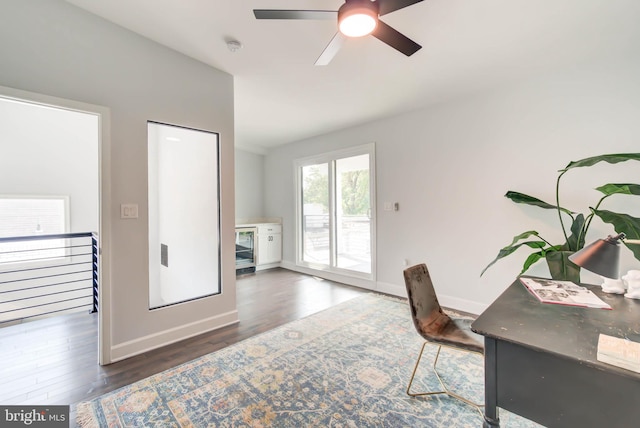 office with ceiling fan and dark hardwood / wood-style flooring