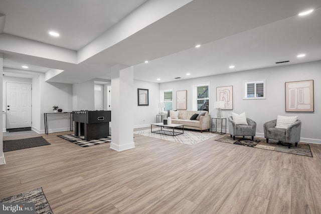 living room featuring wood finished floors, recessed lighting, and baseboards