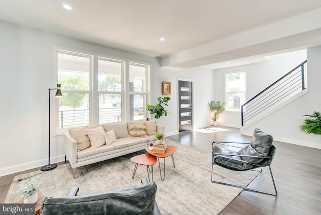 living area with recessed lighting, stairway, wood finished floors, and baseboards