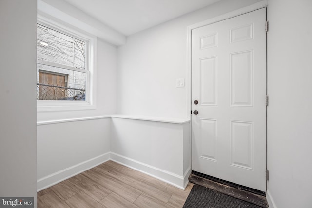 entryway with light wood-style floors and baseboards