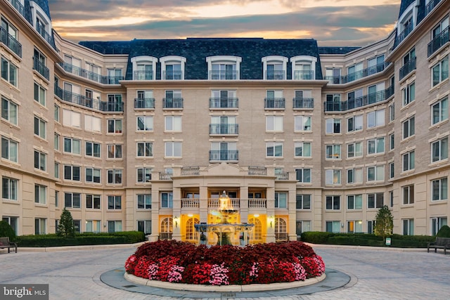 view of outdoor building at dusk