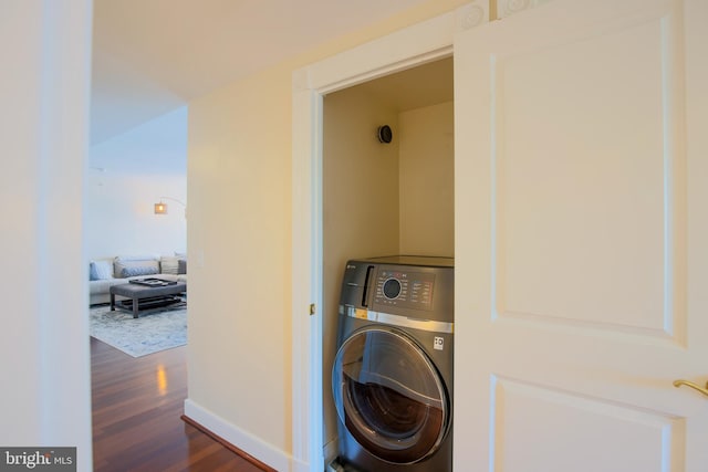 laundry room with washer / dryer and dark hardwood / wood-style flooring