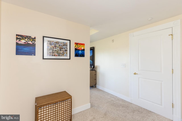 corridor featuring light colored carpet