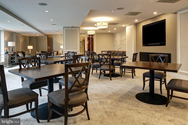 dining room featuring light carpet