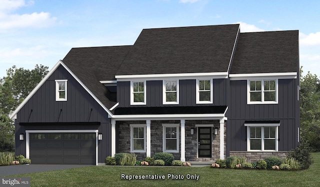 view of front of home with a front yard and a garage