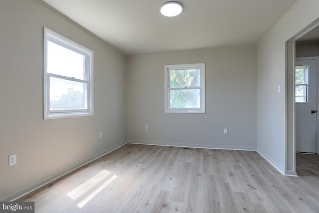 unfurnished room with light hardwood / wood-style floors and a wealth of natural light