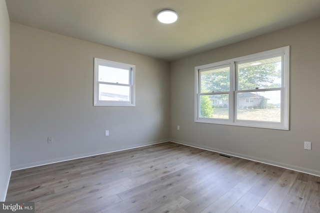 empty room with light hardwood / wood-style floors