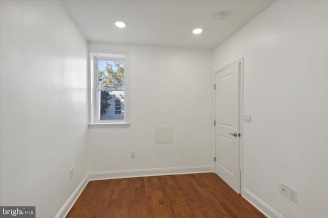 spare room with dark hardwood / wood-style floors