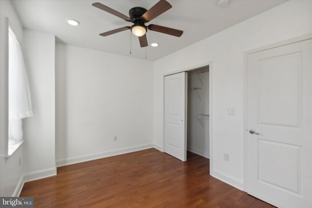 unfurnished bedroom featuring ceiling fan and dark hardwood / wood-style flooring