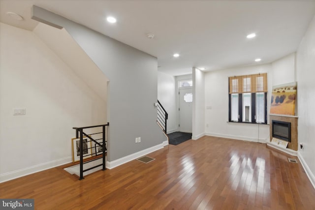 unfurnished living room featuring hardwood / wood-style floors