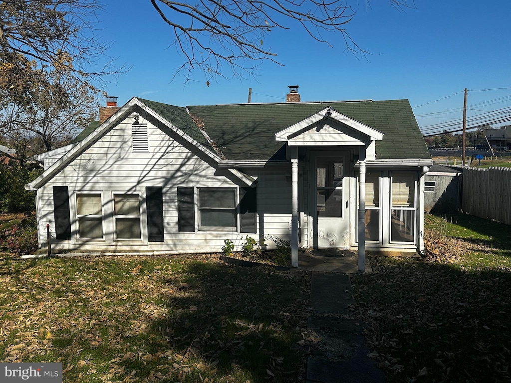 rear view of house with a lawn