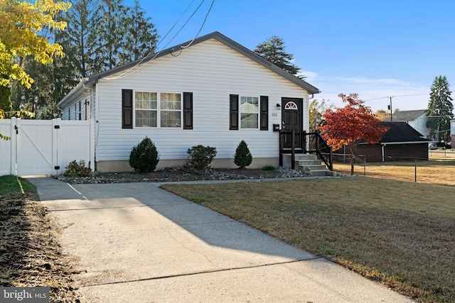 bungalow-style home featuring a front lawn