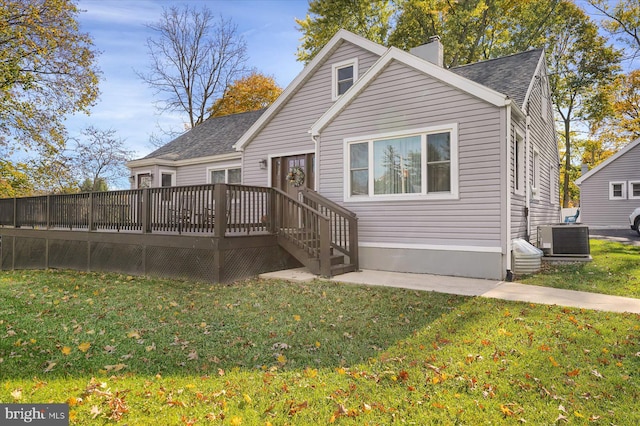 rear view of house with central AC, a lawn, and a deck