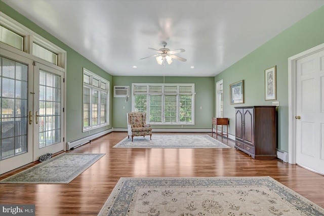 unfurnished room featuring french doors, a baseboard heating unit, hardwood / wood-style flooring, and ceiling fan