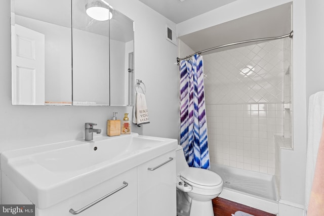 bathroom featuring toilet, vanity, hardwood / wood-style floors, and a shower with shower curtain