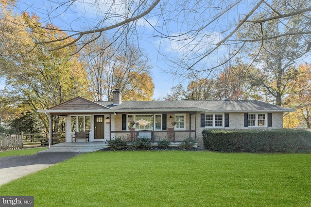 view of front of home with a porch and a front yard