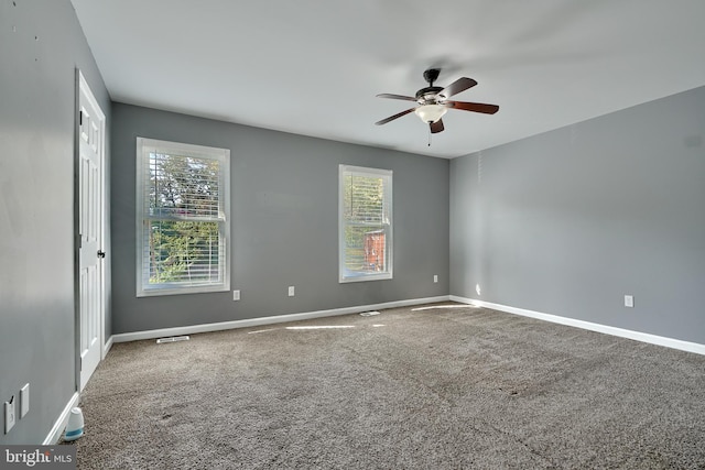 carpeted spare room with ceiling fan