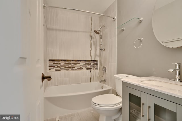 full bathroom featuring vanity, tiled shower / bath combo, toilet, and tile patterned flooring