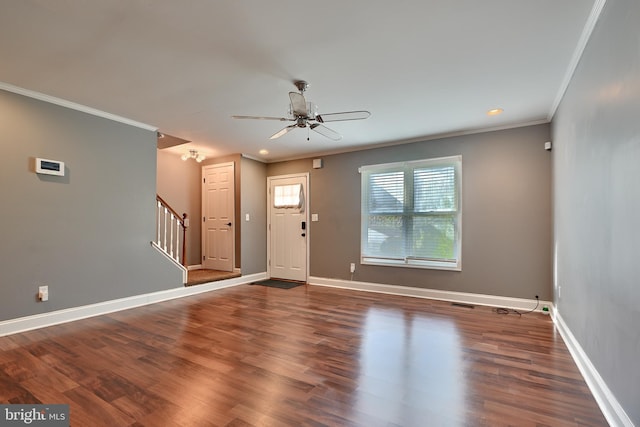 entrance foyer with ornamental molding, dark hardwood / wood-style floors, and ceiling fan