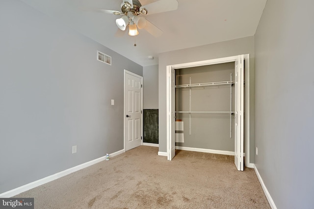 unfurnished bedroom featuring light colored carpet, a closet, and ceiling fan