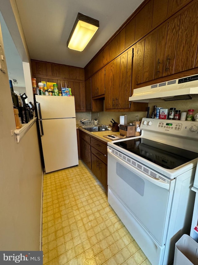 kitchen with sink and white appliances