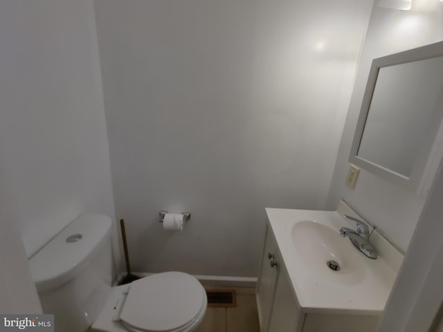 bathroom with vanity, toilet, and tile patterned flooring