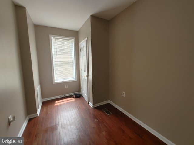 spare room with dark hardwood / wood-style floors