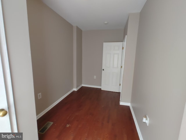 corridor with dark hardwood / wood-style floors