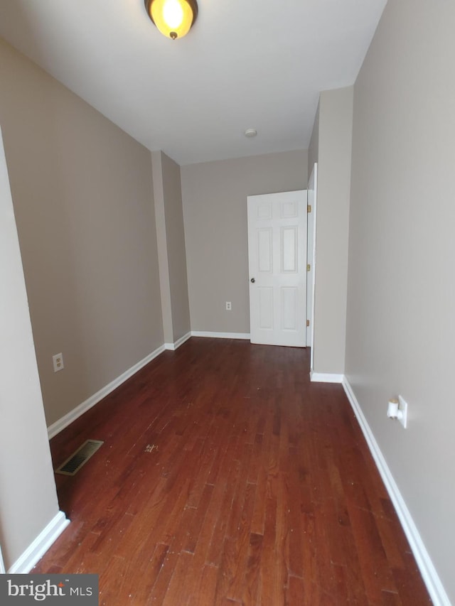 empty room with dark hardwood / wood-style floors