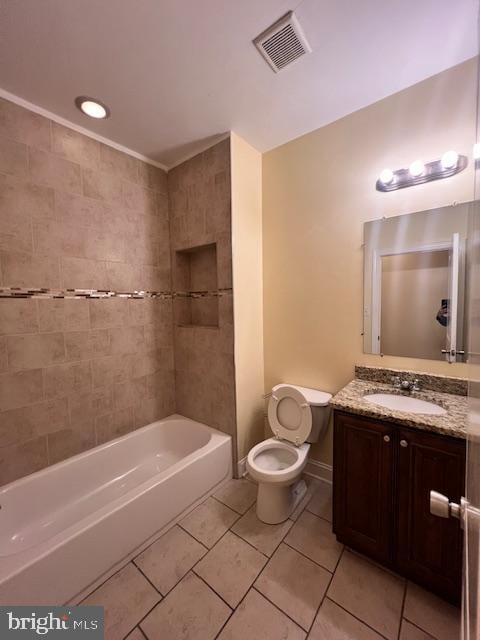 full bathroom with tiled shower / bath, vanity, toilet, and tile patterned floors