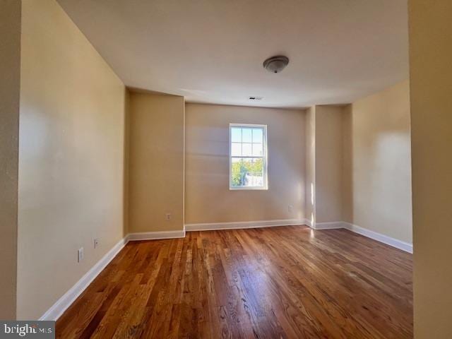 unfurnished room featuring dark hardwood / wood-style flooring