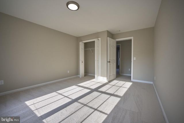 unfurnished bedroom featuring a closet and light colored carpet