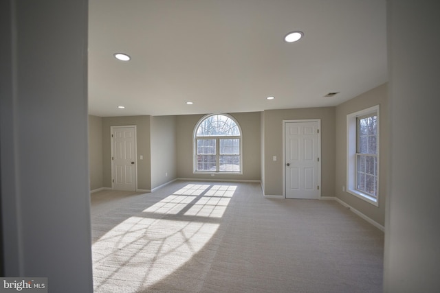 unfurnished room featuring light carpet