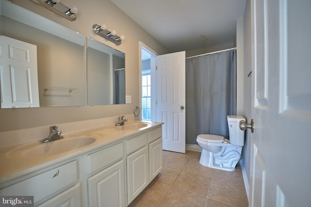 bathroom featuring toilet, vanity, and tile patterned floors