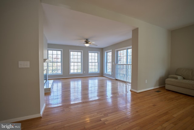 unfurnished living room with ceiling fan and light hardwood / wood-style floors