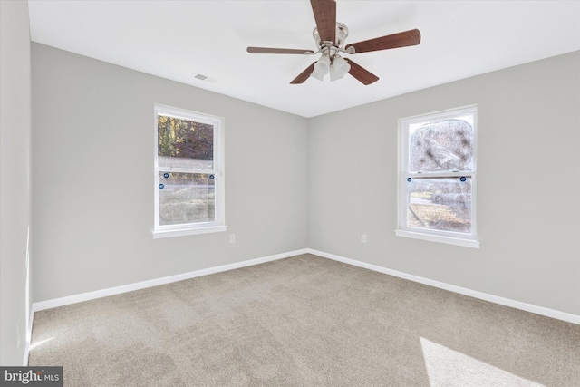 spare room featuring carpet floors and ceiling fan