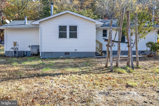 rear view of property featuring central AC