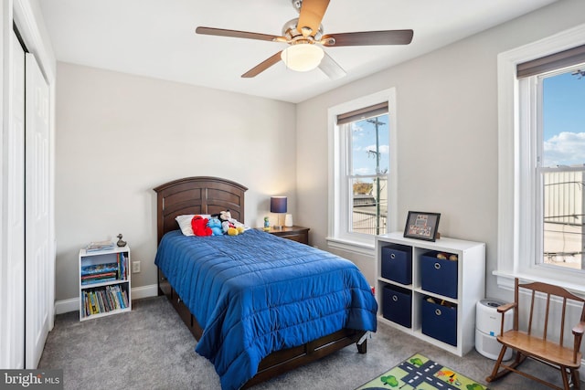 carpeted bedroom featuring ceiling fan and a closet