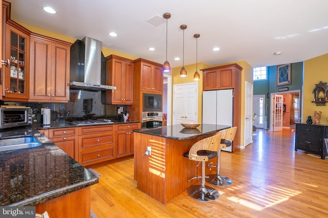 10 Eddie Ct, Dayton, NJ 08810 - kitchen with light wood-type flooring, pendant lighting, stainless steel appliances, backsplash, and wall chimney exhaust hood
