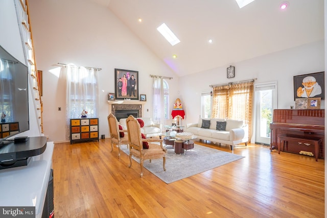 10 Eddie Ct, Dayton, NJ 08810 - living room featuring recessed lighting, a skylight, a fireplace, light wood-style flooring, and high vaulted ceiling