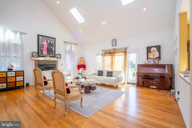 10 Eddie Ct, Dayton, NJ 08810 - living room with high vaulted ceiling, a glass covered fireplace, wood finished floors, and a skylight