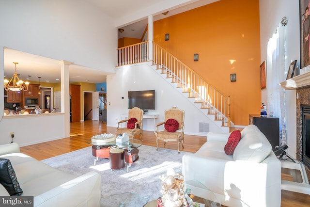 10 Eddie Ct, Dayton, NJ 08810 - living area with wood finished floors, a high ceiling, stairs, and decorative columns