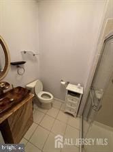 10 Eddie Ct, Dayton, NJ 08810 - full bath featuring a tile shower, toilet, and tile patterned flooring