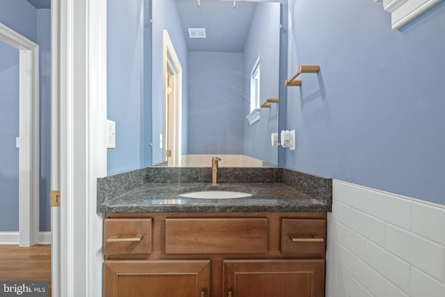 bathroom with vanity, tile walls, and hardwood / wood-style flooring