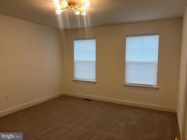 106 Berkshire Dr, Carlisle, PA 17015 - empty room with dark colored carpet, a chandelier, and baseboards